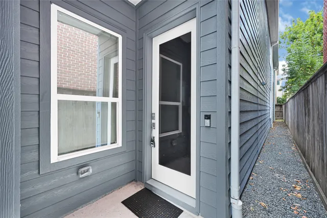 a view of a wooden door with a bench