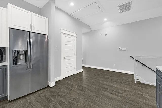 a view of a refrigerator in kitchen and wooden floor