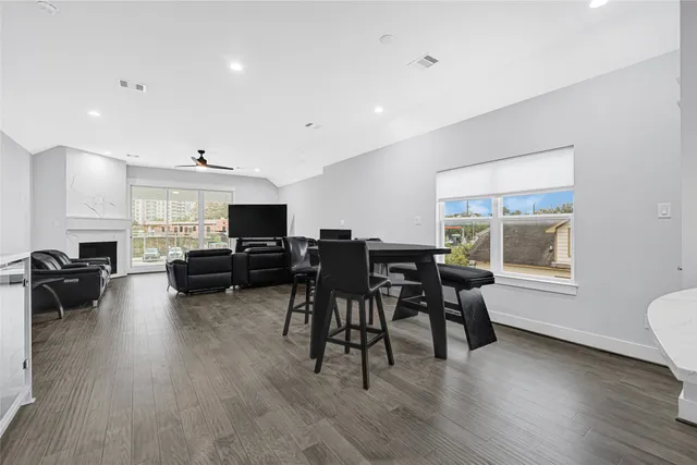 a living room with furniture wooden floor and a flat screen tv