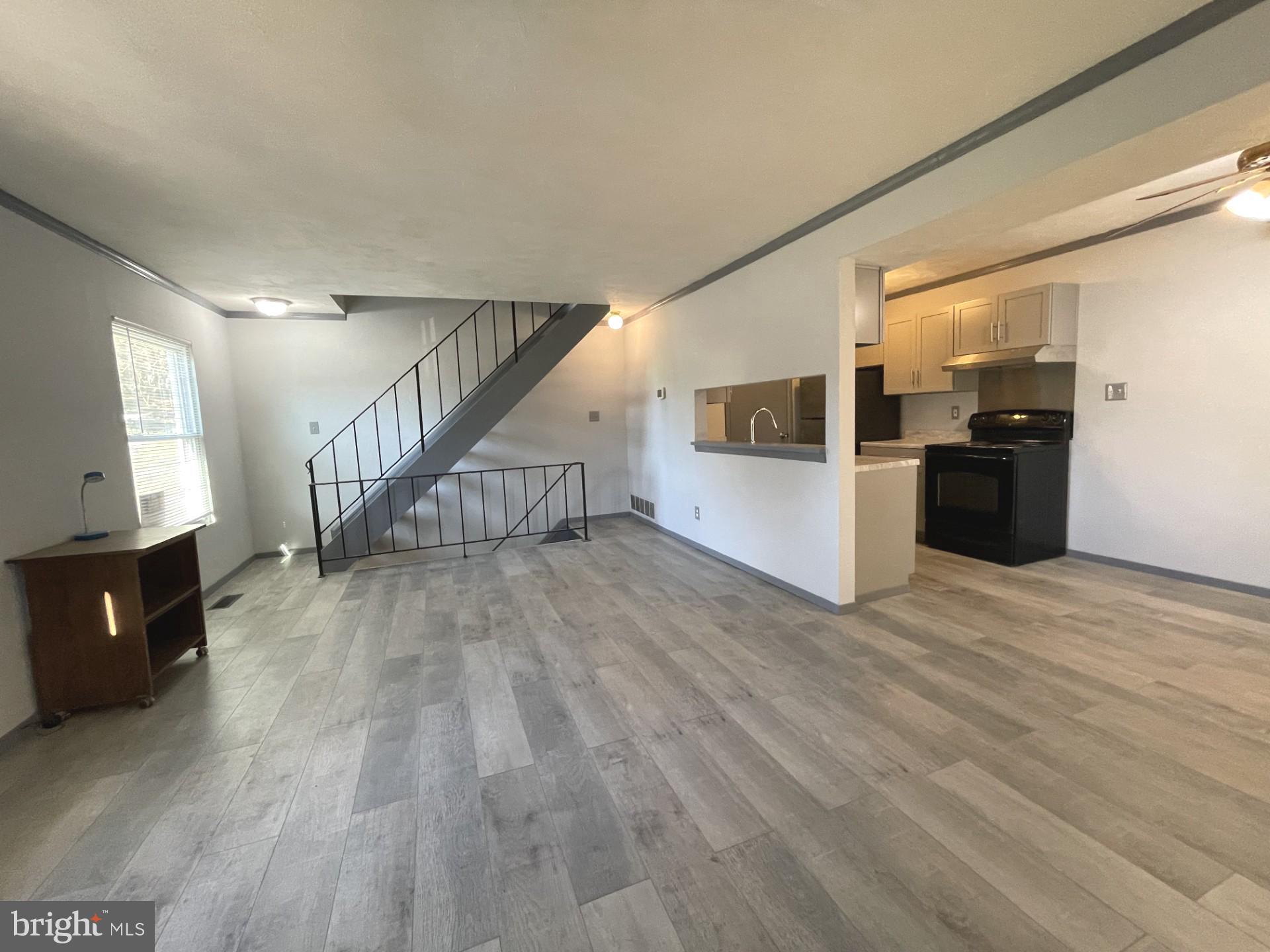 6 Ridgelawn Road, Unit C Reisterstown, MD 21136 - Photo 12 of 28 a view of a living room with kitchen and wooden floor