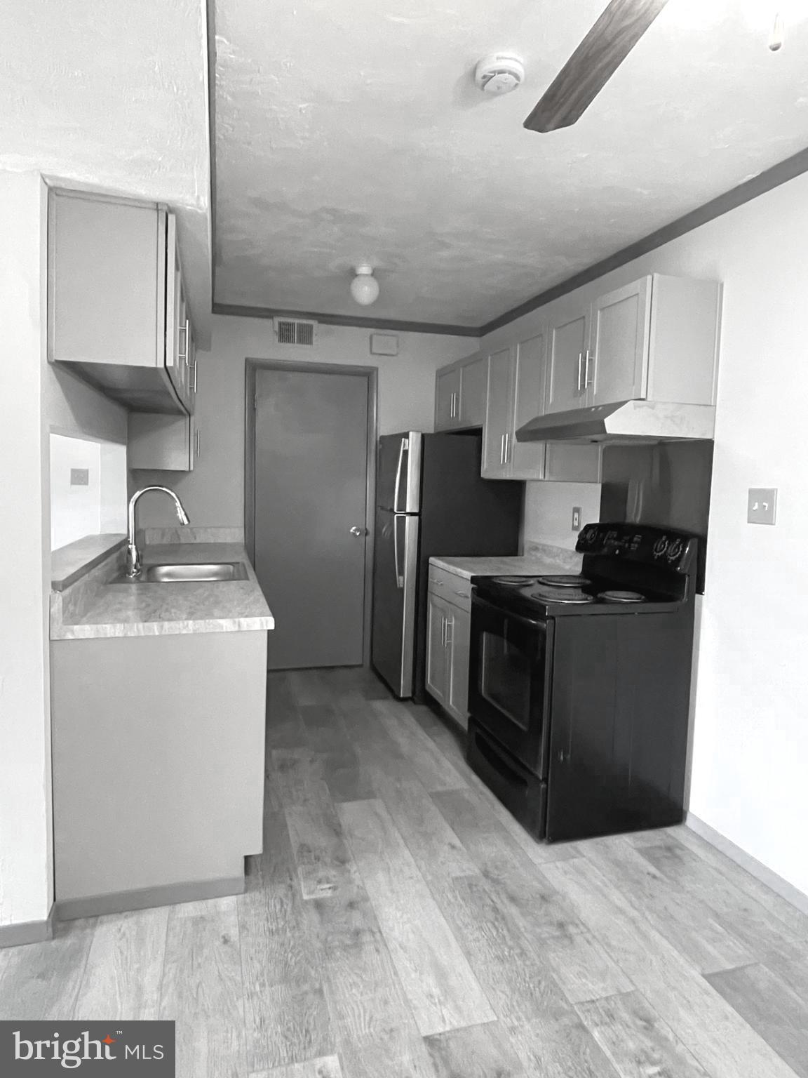 6 Ridgelawn Road, Unit C Reisterstown, MD 21136 - Photo 14 of 28 a kitchen with a refrigerator sink and cabinets
