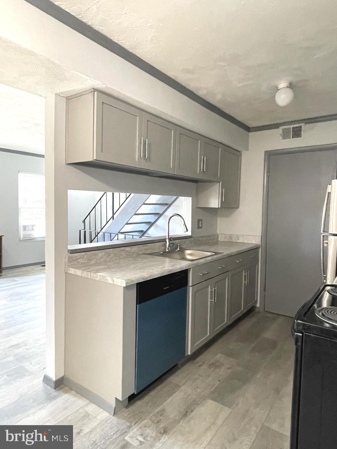 6 Ridgelawn Road, Unit C Reisterstown, MD 21136 - Photo 15 of 28 a kitchen with granite countertop a sink stainless steel appliances and cabinets