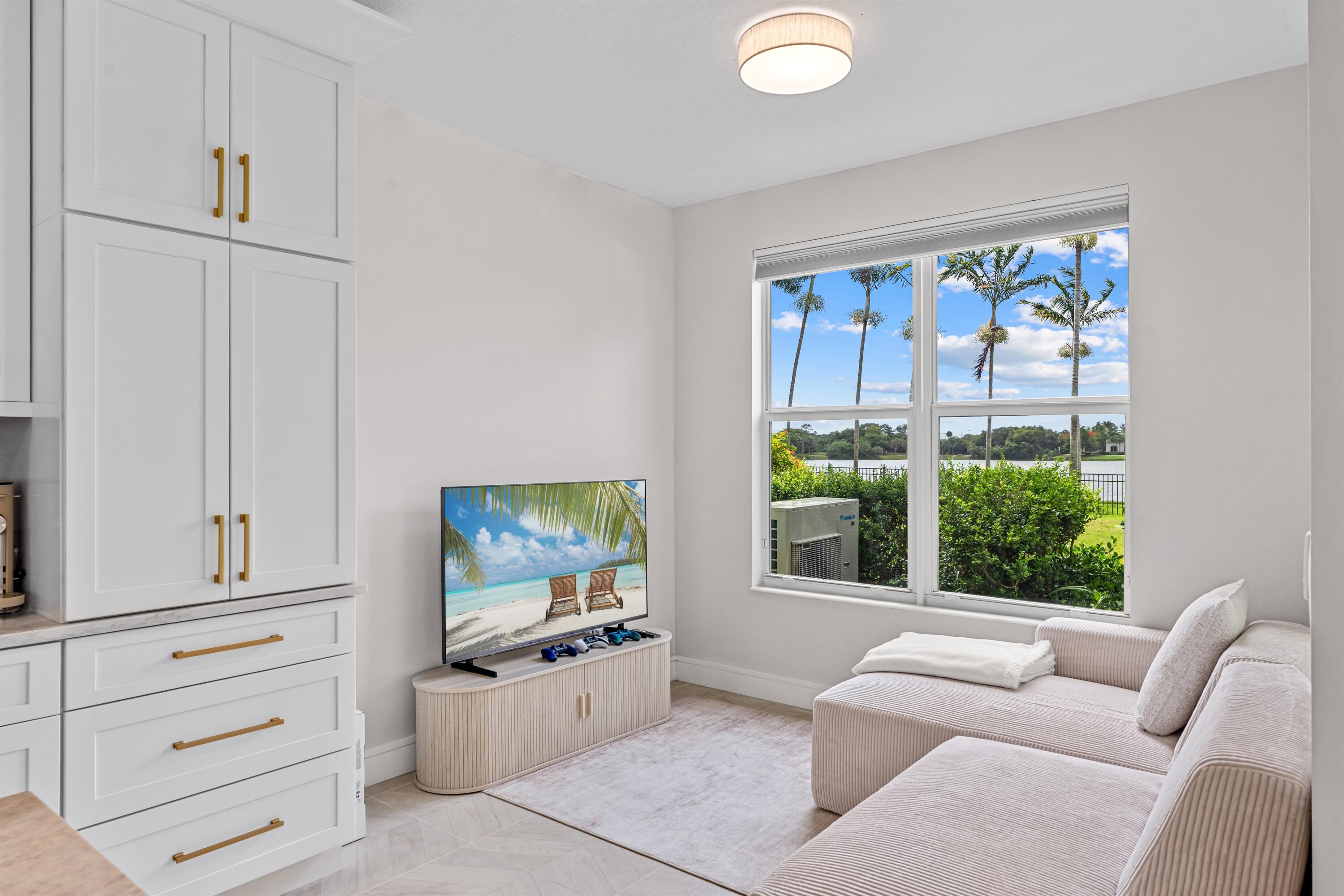 1570 Northwest 48th Place Boca Raton, FL 33431 - Photo 8 of 30 a living room with furniture and a flat screen tv
