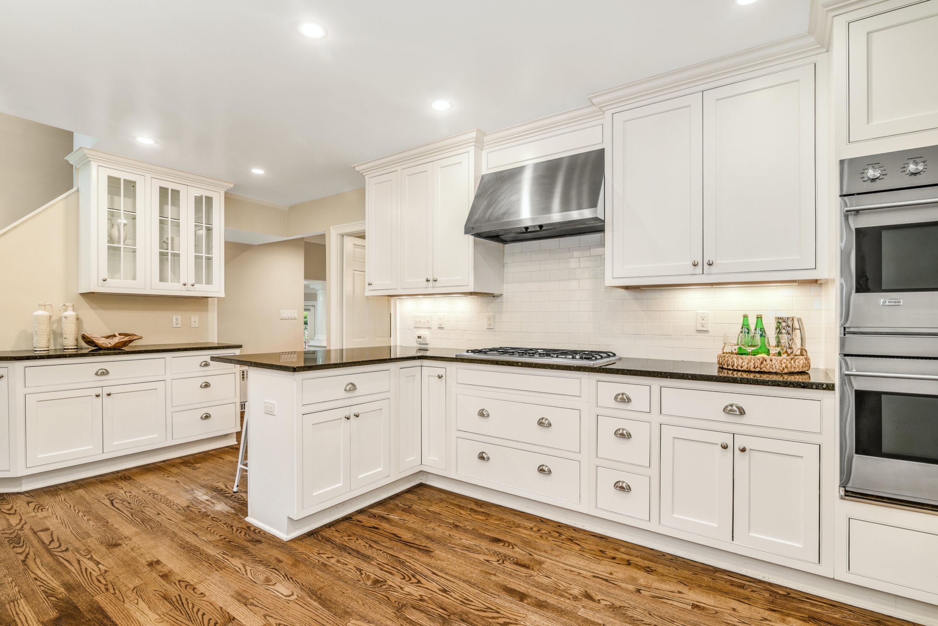 22 Stony Brook Road Darien, CT 06820 - Photo 11 of 33 a kitchen with granite countertop white cabinets and white appliances