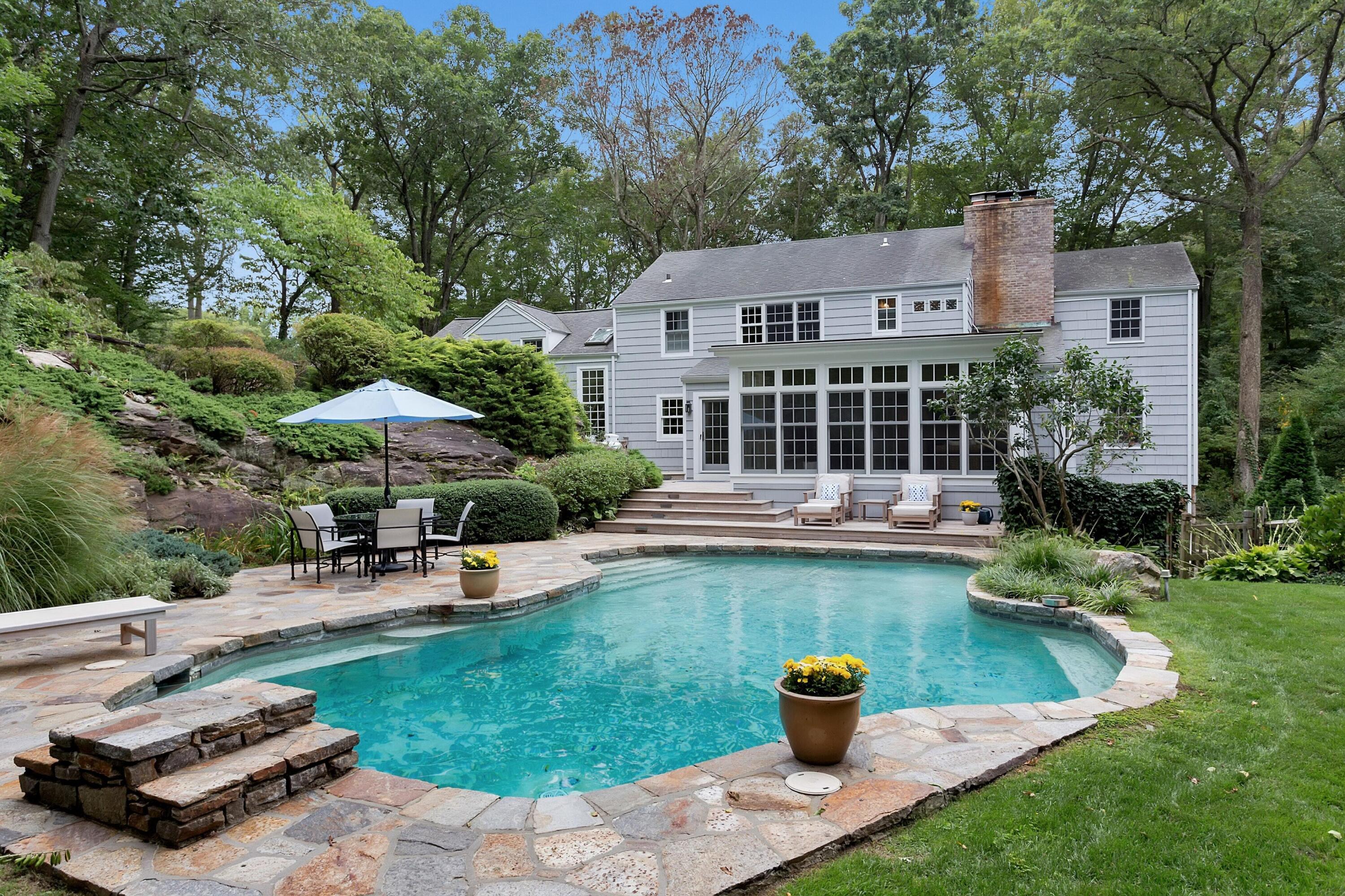 22 Stony Brook Road Darien, CT 06820 - Photo 31 of 33 a view of a house with pool and chairs