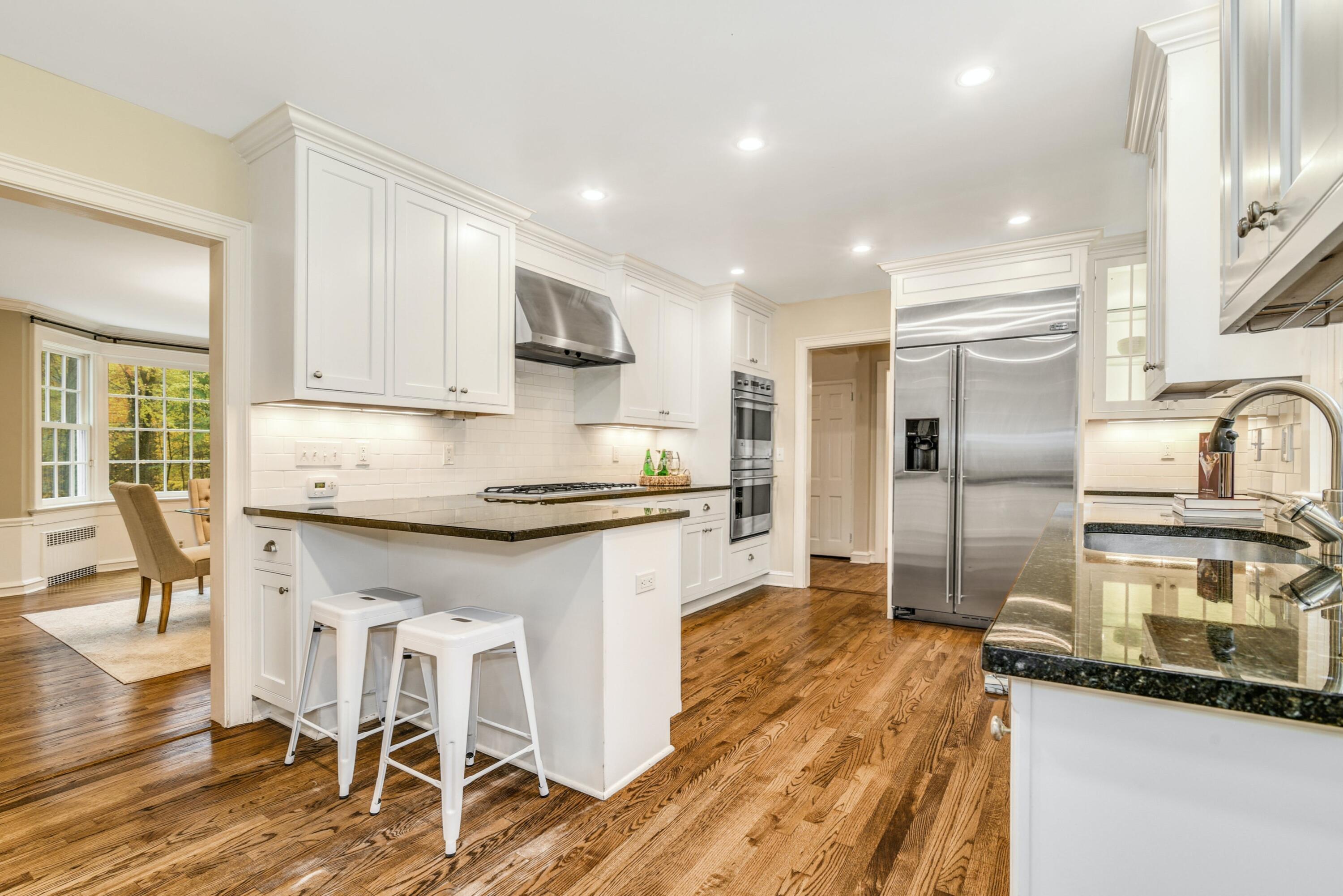 22 Stony Brook Road Darien, CT 06820 - Photo 8 of 33 a kitchen with granite countertop a stove a sink and a refrigerator
