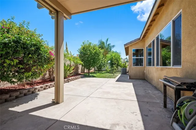 a view of a house with backyard and porch