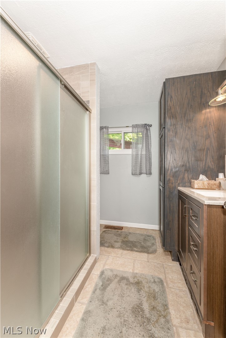 2740 Ranfield Road Mogadore, OH 44260 - Photo 29 of 33 Full bath on 1st level , recently updated with newer shower, cabinetry, flooring.
..services bedroom #4.