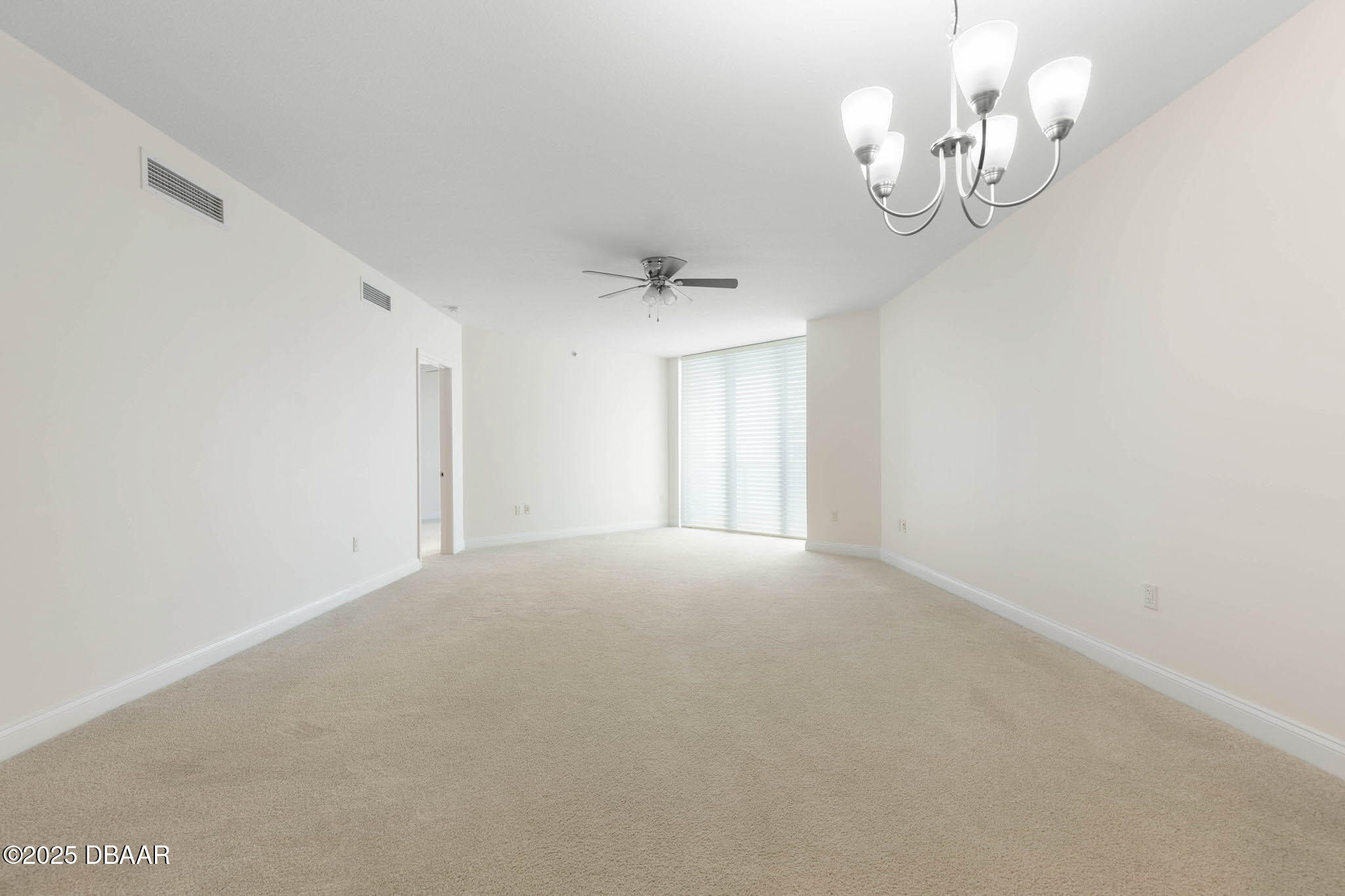231 Riverside Drive, Unit 608 Holly Hill, FL 32117 - Photo 17 of 74 a view of an empty room with a chandelier fan
