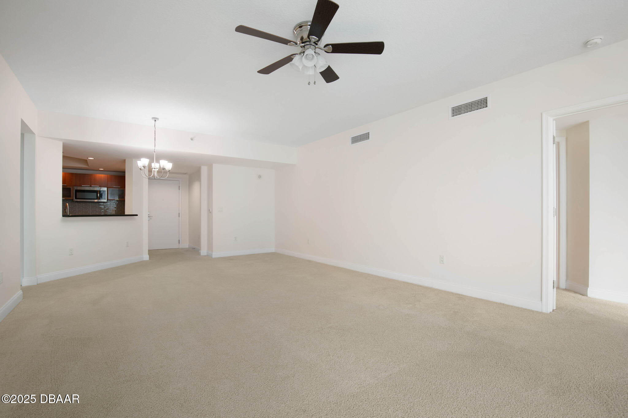 231 Riverside Drive, Unit 608 Holly Hill, FL 32117 - Photo 18 of 74 an empty room with a empty space and a ceiling fan