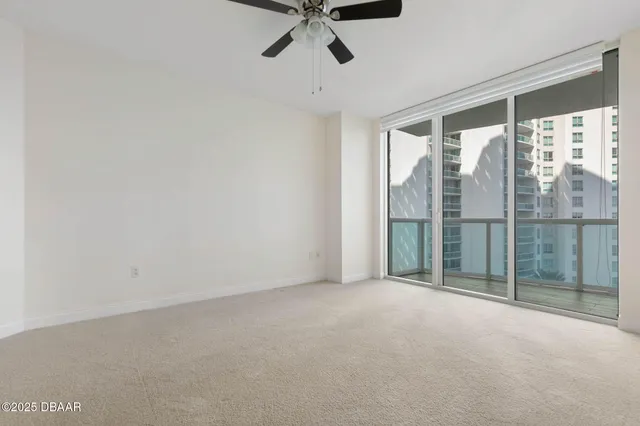 a view of a balcony with a floor to ceiling window and wooden floor