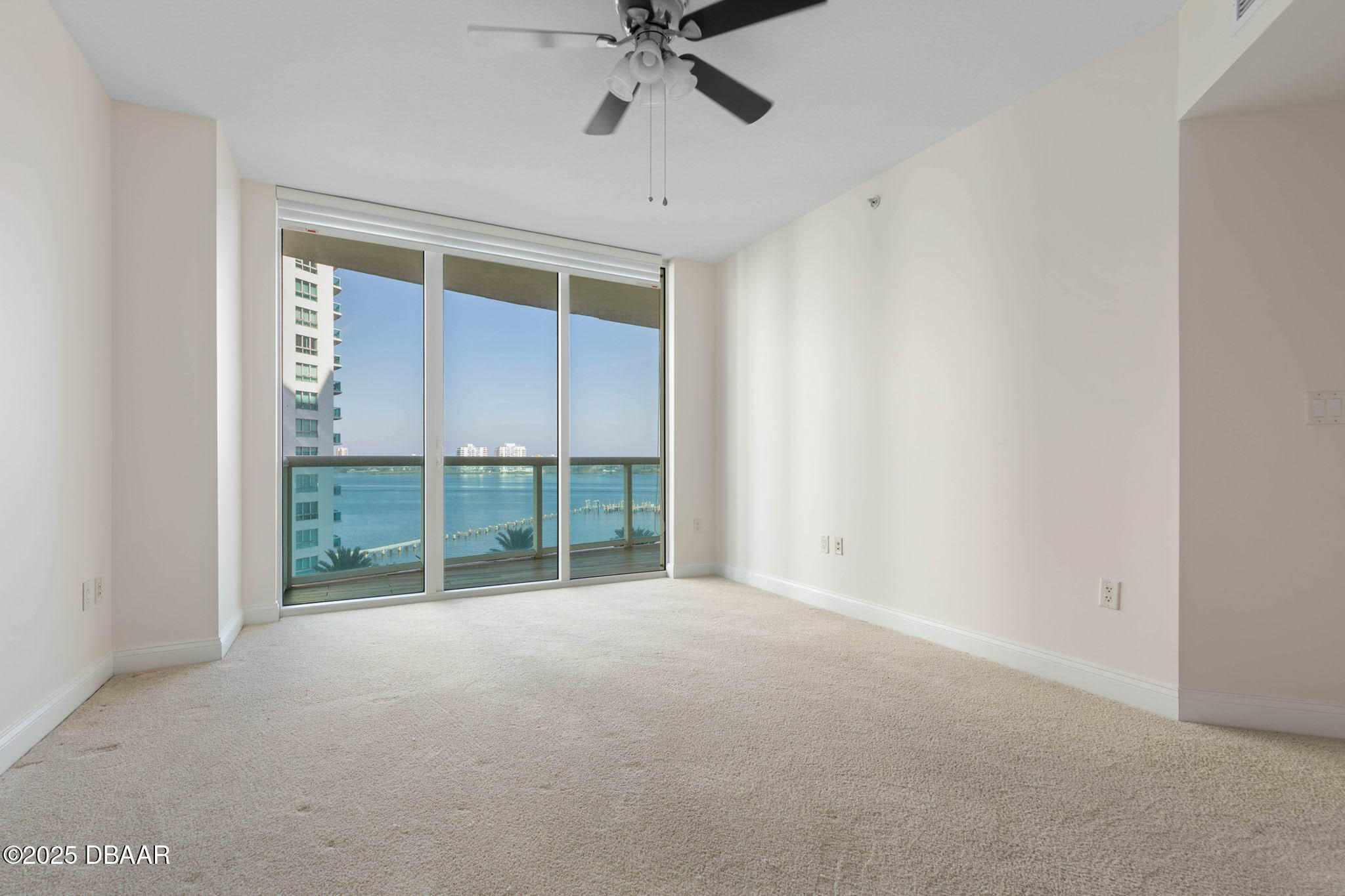 231 Riverside Drive, Unit 608 Holly Hill, FL 32117 - Photo 24 of 74 an empty room with windows and ceiling fan