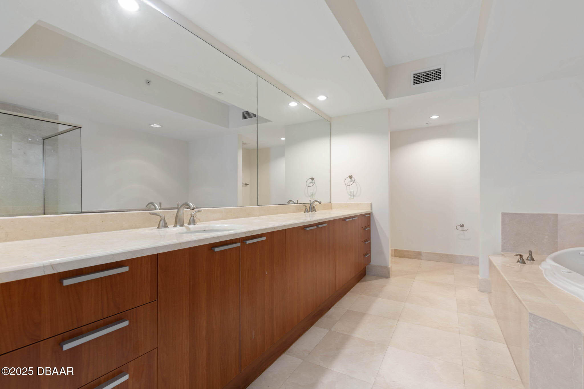 231 Riverside Drive, Unit 608 Holly Hill, FL 32117 - Photo 27 of 74 a large white kitchen with a sink and a large mirror