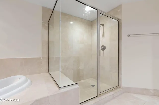 an empty room with a window and a ceiling fan