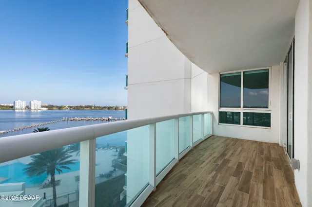 a view of balcony with floor to ceiling window and wooden floor