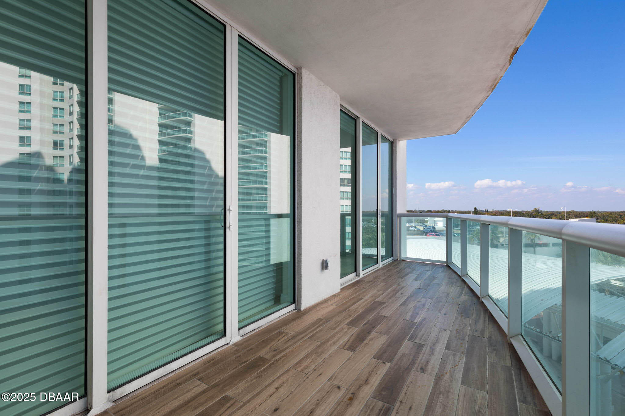 231 Riverside Drive, Unit 608 Holly Hill, FL 32117 - Photo 6 of 74 a view of balcony with floor to ceiling window and wooden floor