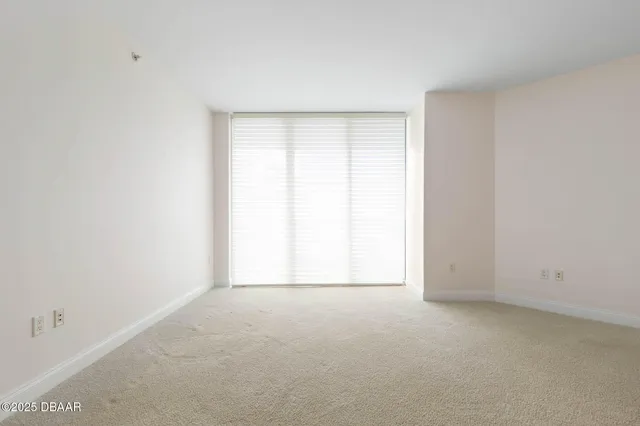 a view of empty room with ceiling fan