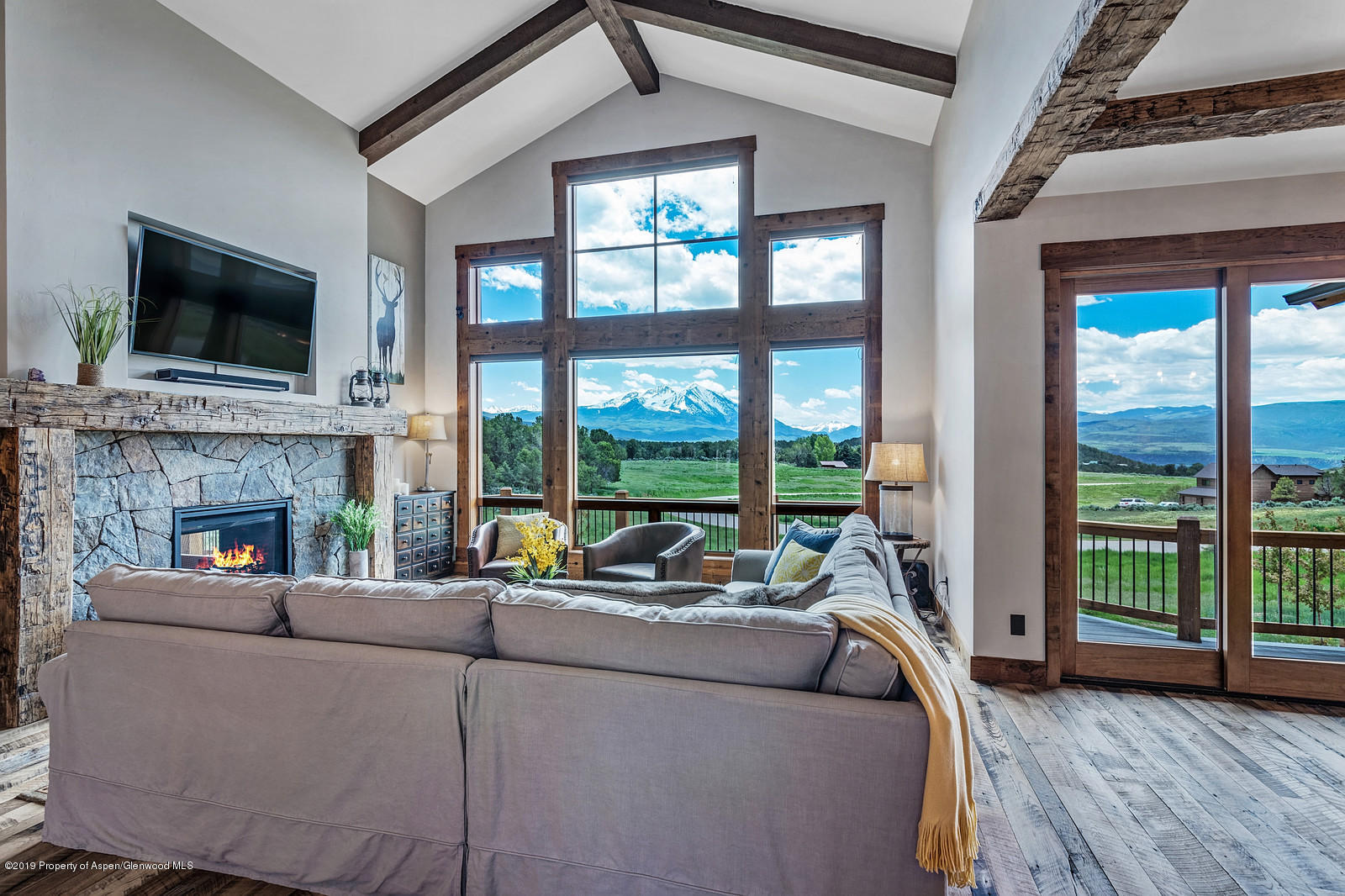 a living room with fireplace furniture and a flat screen tv