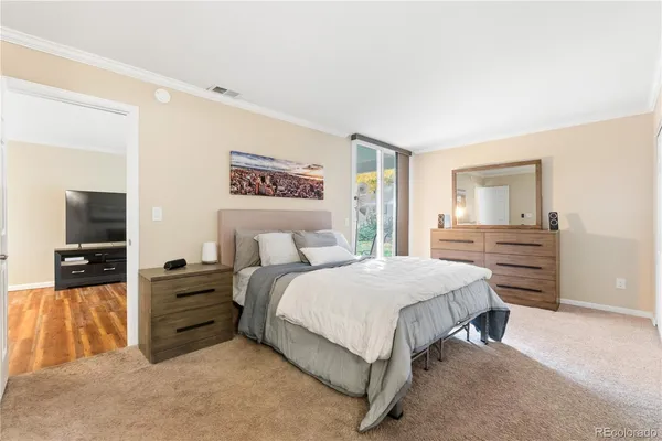 a bedroom with a bed and a television