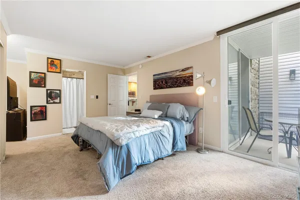 a bedroom with bed and a chandelier