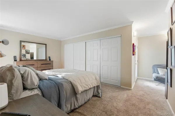 a bedroom with a bed and a couch