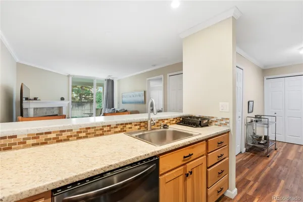 a kitchen with stainless steel appliances granite countertop a sink stove and cabinets
