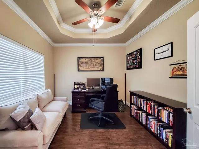 a living room with furniture and a book shelf