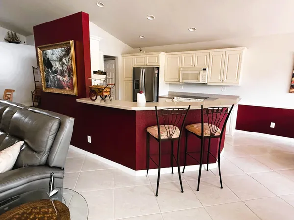 a white refrigerator freezer and a stove sitting inside of a kitchen
