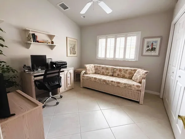 a view of a chairs and tables in the back yard of the house