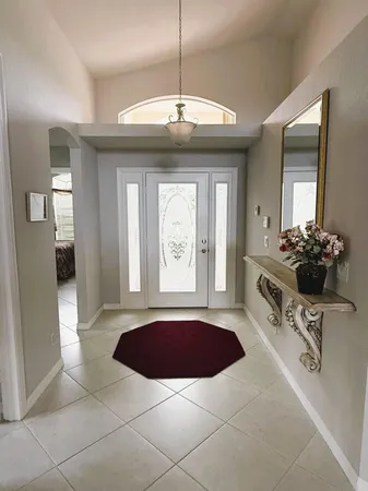 a view of a kitchen with a sink and a large mirror