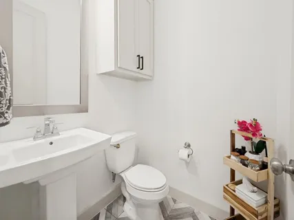 a bathroom with a sink toilet and a mirror
