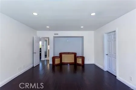 a view of room with hardwood floor and cabinet