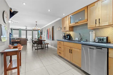 a kitchen with stainless steel appliances kitchen island granite countertop a sink and cabinets