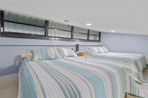 a bedroom with double bed and a night stand