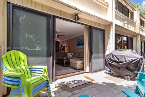 a view of a patio with a table and chairs