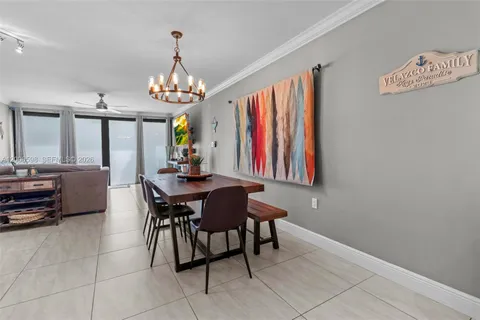 a view of a dining room with furniture and a chandelier