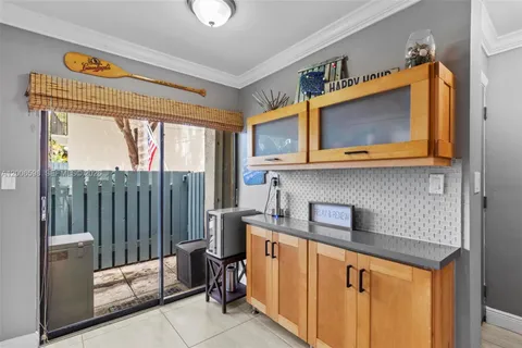a kitchen with stainless steel appliances granite countertop a microwave a stove and white cabinets