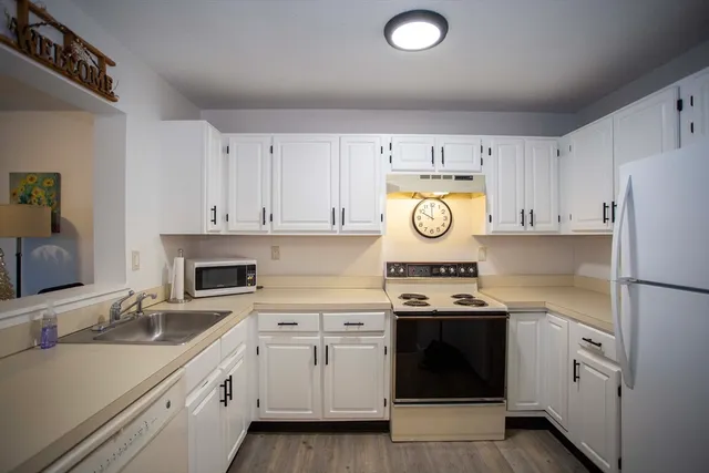 a kitchen with cabinets and stainless steel appliances