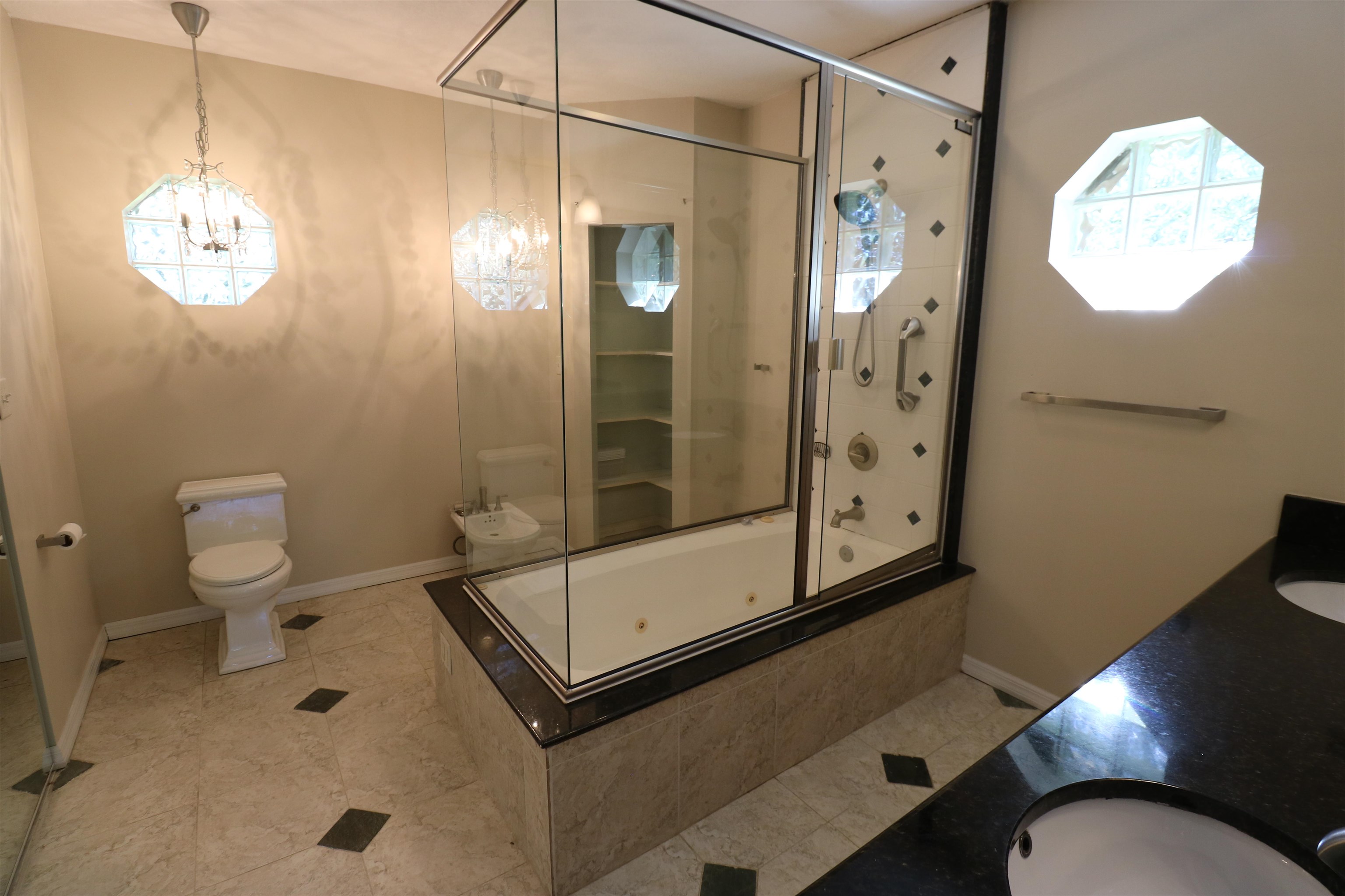 5861 Datil Pepper Road St. Augustine, FL 32086 - Photo 18 of 27 Bathroom with bath / shower combo with glass door, vanity, light tile patterned floors, and a chandelier