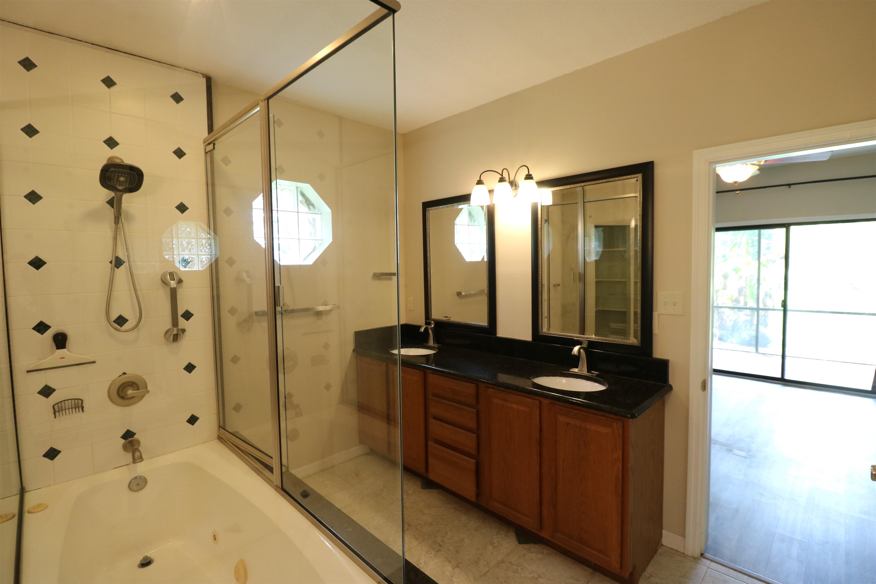 5861 Datil Pepper Road St. Augustine, FL 32086 - Photo 19 of 27 Bathroom featuring double vanity, combined bath / shower with glass door, and light tile patterned flooring