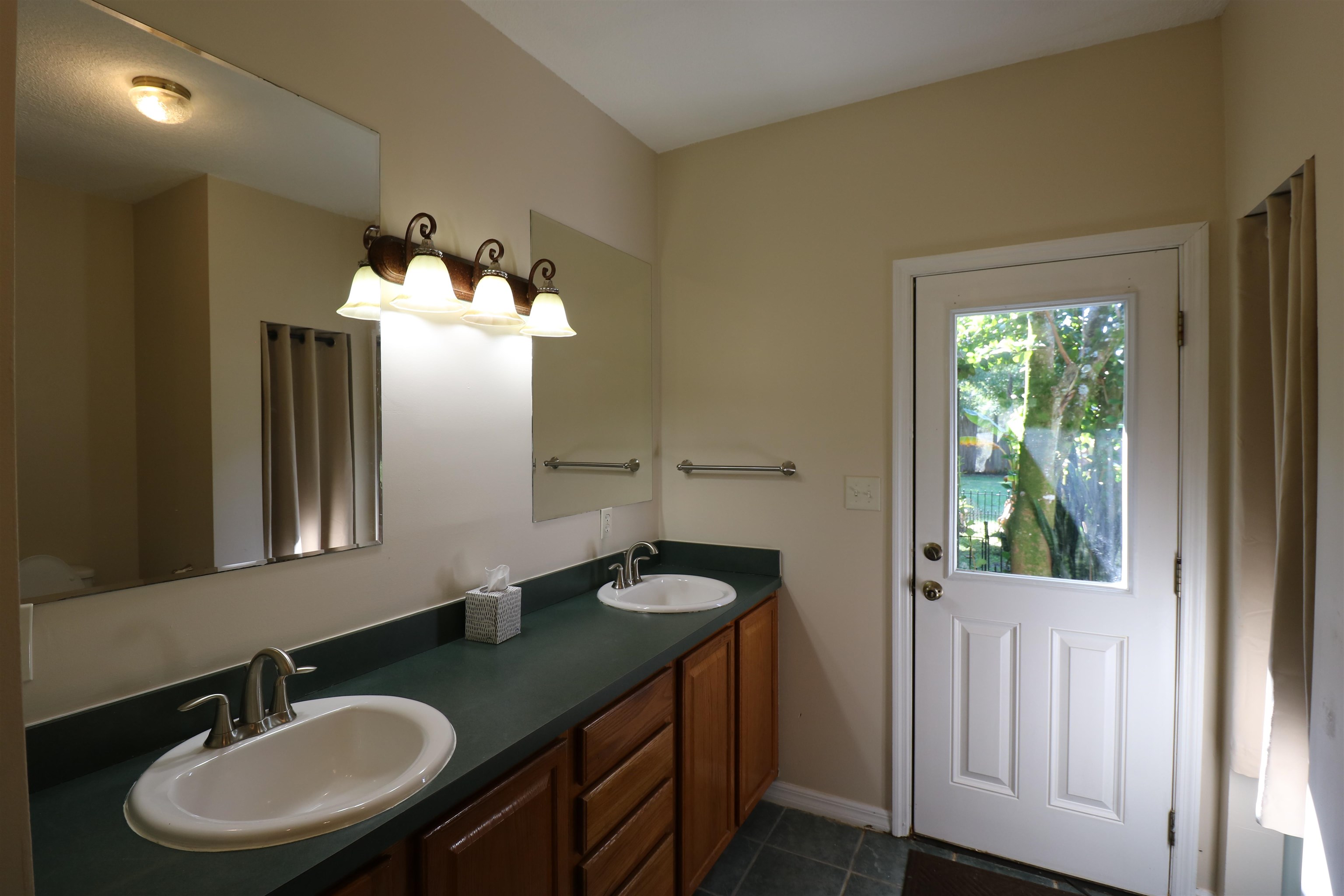 5861 Datil Pepper Road St. Augustine, FL 32086 - Photo 23 of 27 Full bath featuring double vanity and dark tile patterned floors