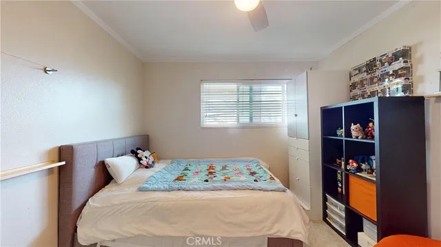 a bedroom with a bed and a book shelf