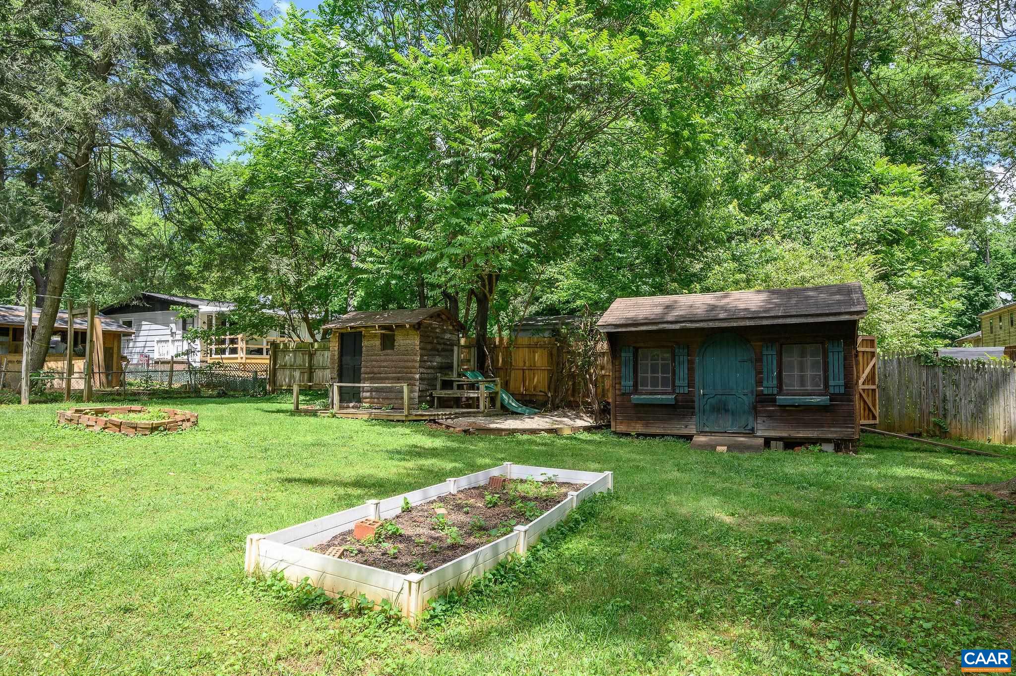 109 Middlesex Drive Charlottesville, VA 22901 - Photo 22 of 27 a front view of a house with a garden and trees