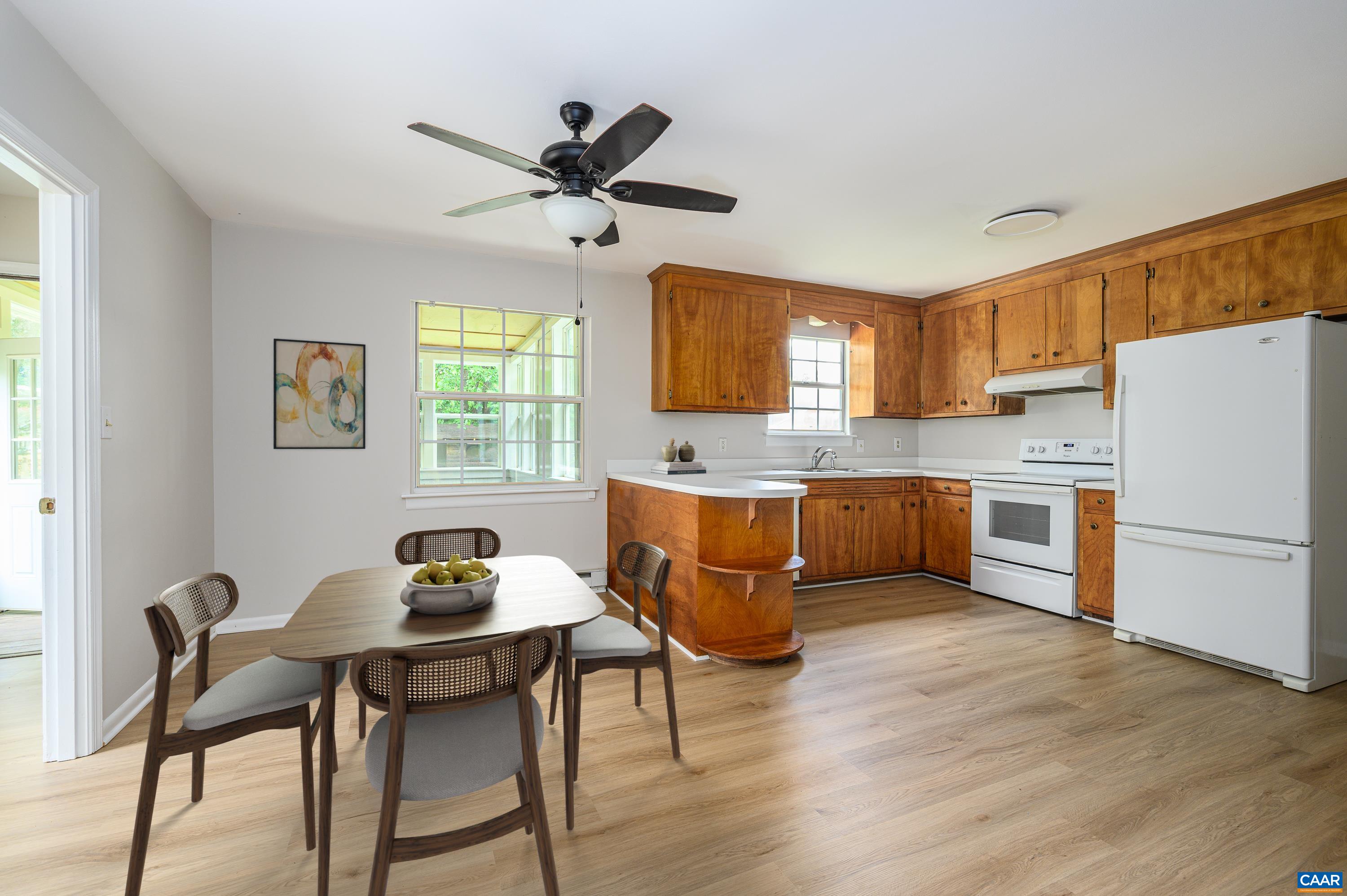 109 Middlesex Drive Charlottesville, VA 22901 - Photo 6 of 27 a kitchen with a refrigerator a table and chairs