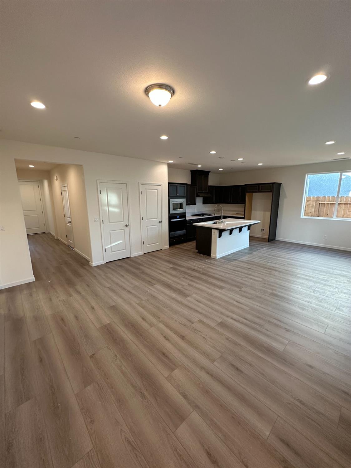 4178 Beverly Avenue Clovis, CA 93619 - Photo 2 of 4 a view of open kitchen with wooden floor and chairs
