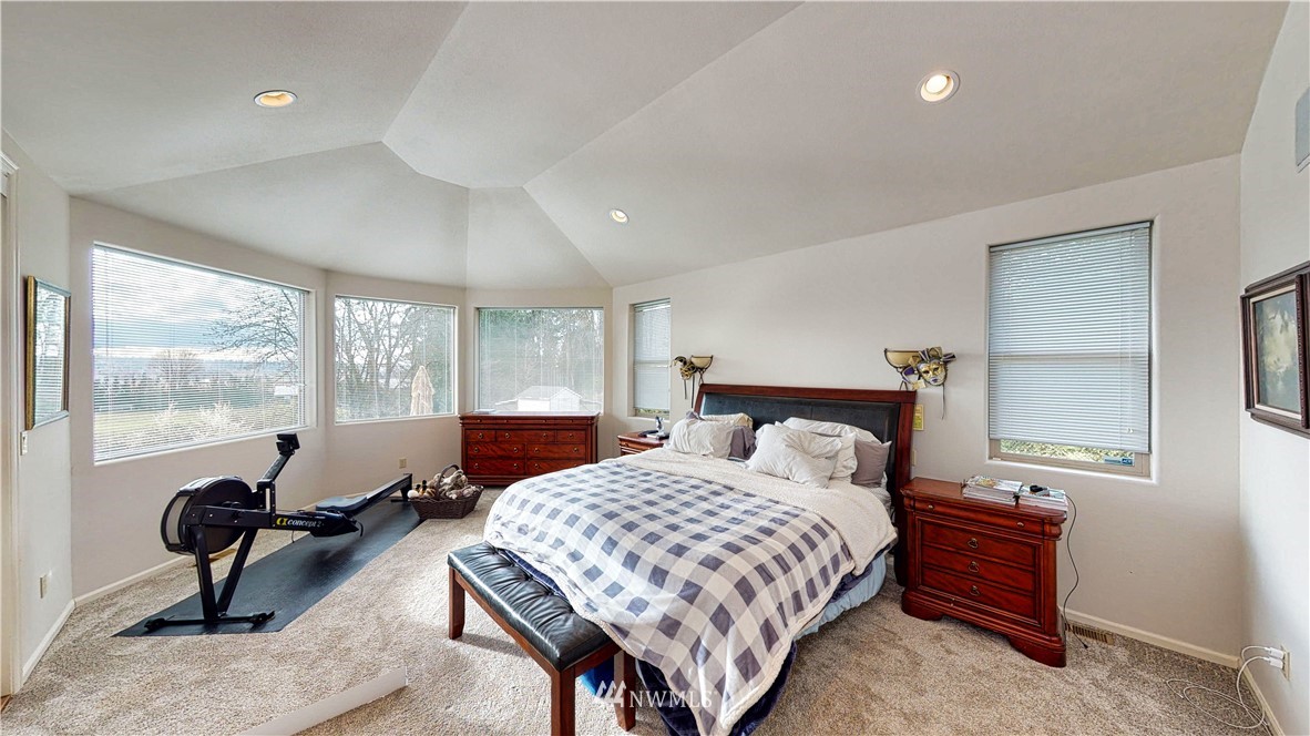 4830 Fobes Road Snohomish, WA 98290 - Photo 24 of 35 a bedroom with a bed and large windows