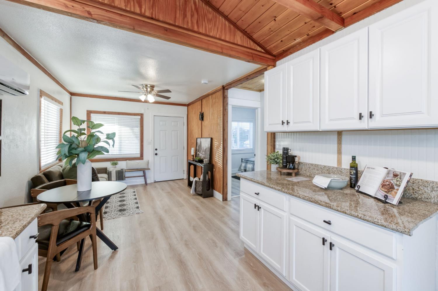 2414 Snyder Street Selma, CA 93662 - Photo 8 of 28 a kitchen with granite countertop a sink chairs and white cabinets