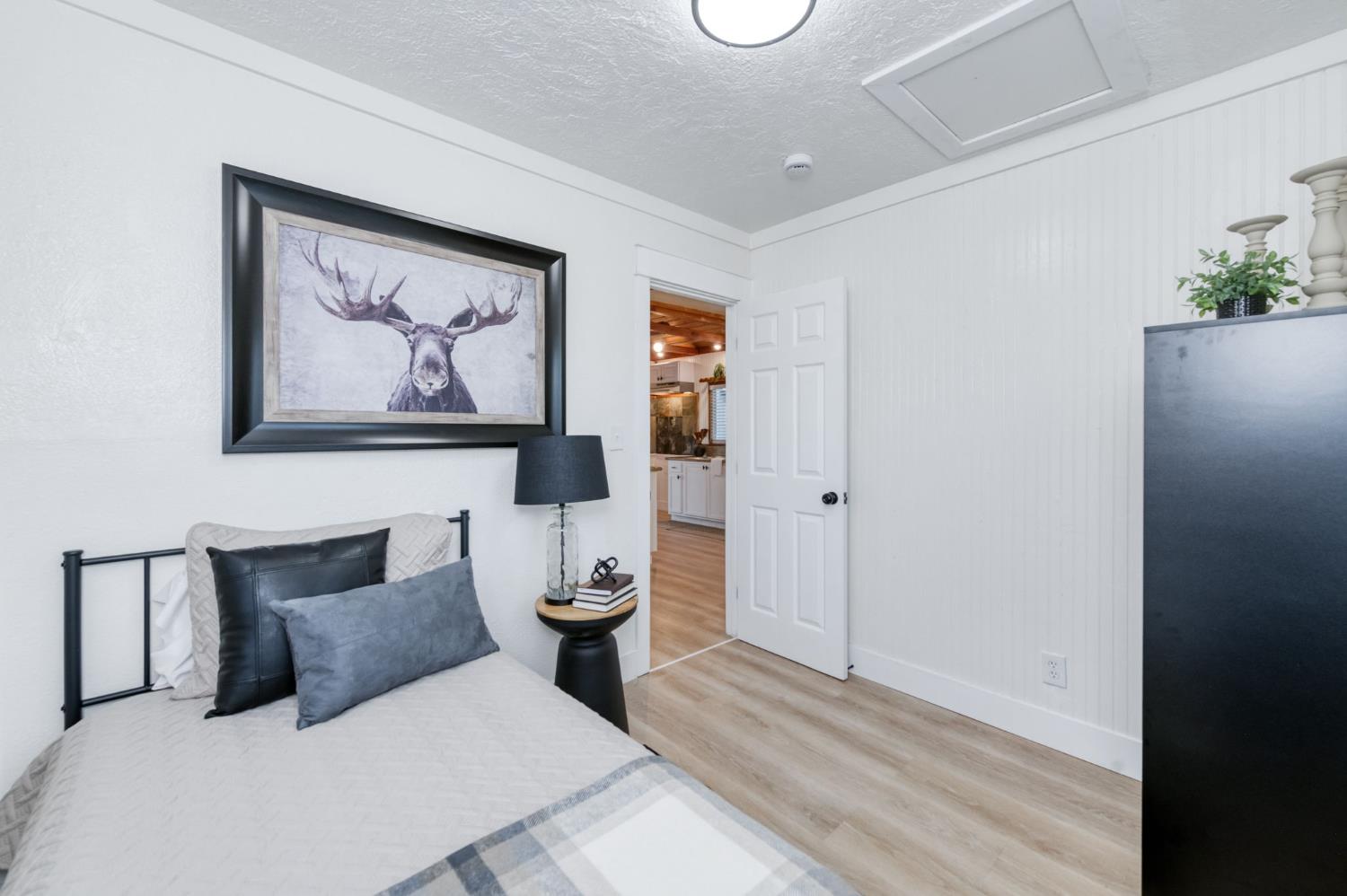 2414 Snyder Street Selma, CA 93662 - Photo 10 of 28 a bathroom with a toilet and a painting on the wall