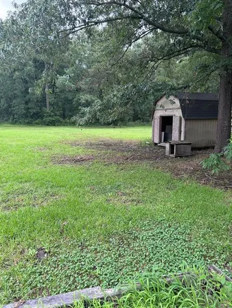 a view of a house with a yard and sitting area