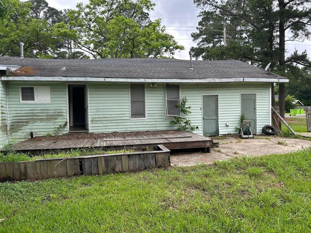 1330 Palmetto Road Benton, LA 71006 - Photo 13 of 13 Back of property featuring a wooden deck, a yard, and a shingled roof